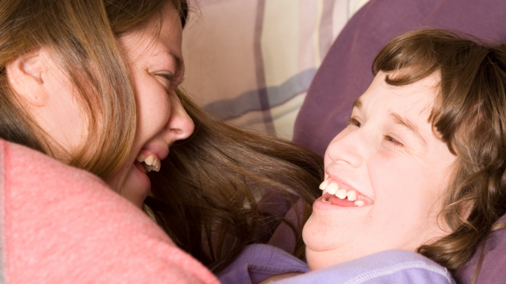 Mother and daughter laugh at personal assistance service.