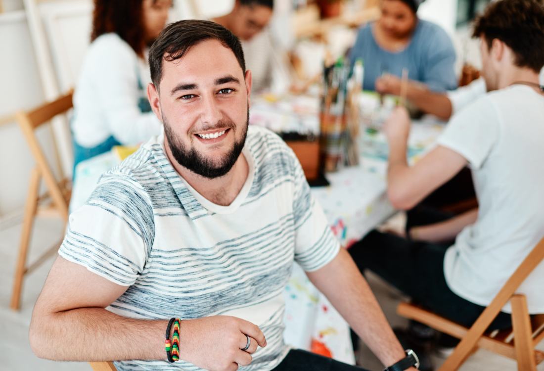 A smiling man in the midst of the meeting
